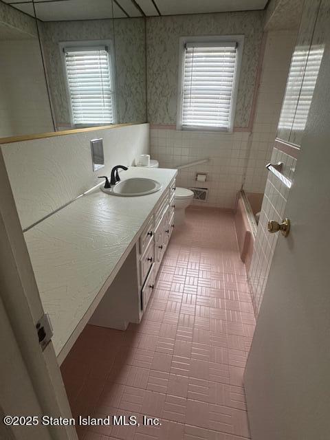 61 Morton Street Staten Island, NY 10306 - Photo 11 of 18 a bathroom with a sink a toilet and a mirror