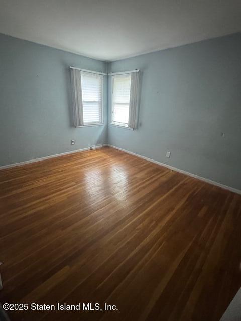 61 Morton Street Staten Island, NY 10306 - Photo 13 of 18 an empty room with wooden floor and windows