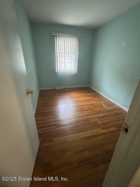 61 Morton Street Staten Island, NY 10306 - Photo 8 of 18 an empty room with wooden floor and windows