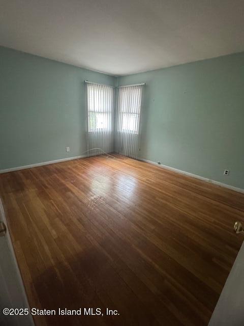 61 Morton Street Staten Island, NY 10306 - Photo 10 of 18 an empty room with wooden floor and windows
