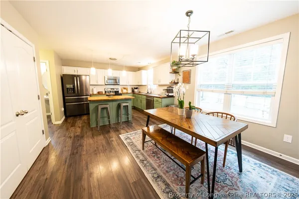 a kitchen with stainless steel appliances granite countertop a sink a stove and microwave