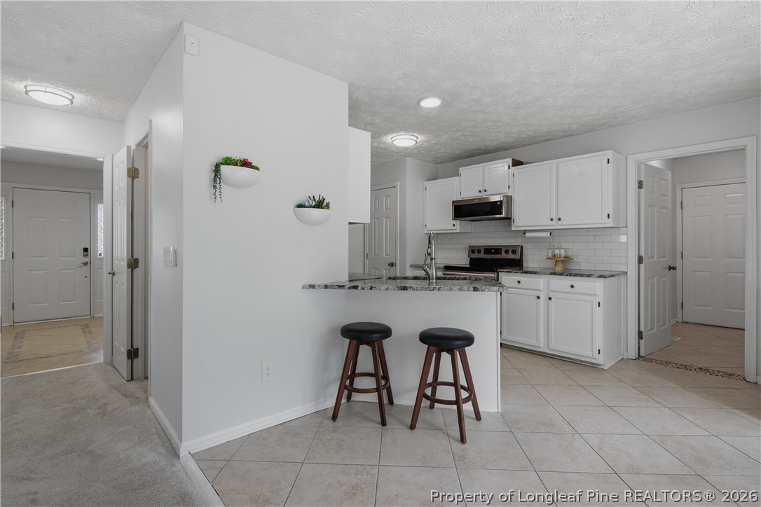 1837 Nuthatch Road Fayetteville, NC 28304 - Photo 16 of 43 a kitchen with a sink cabinets and refrigerator