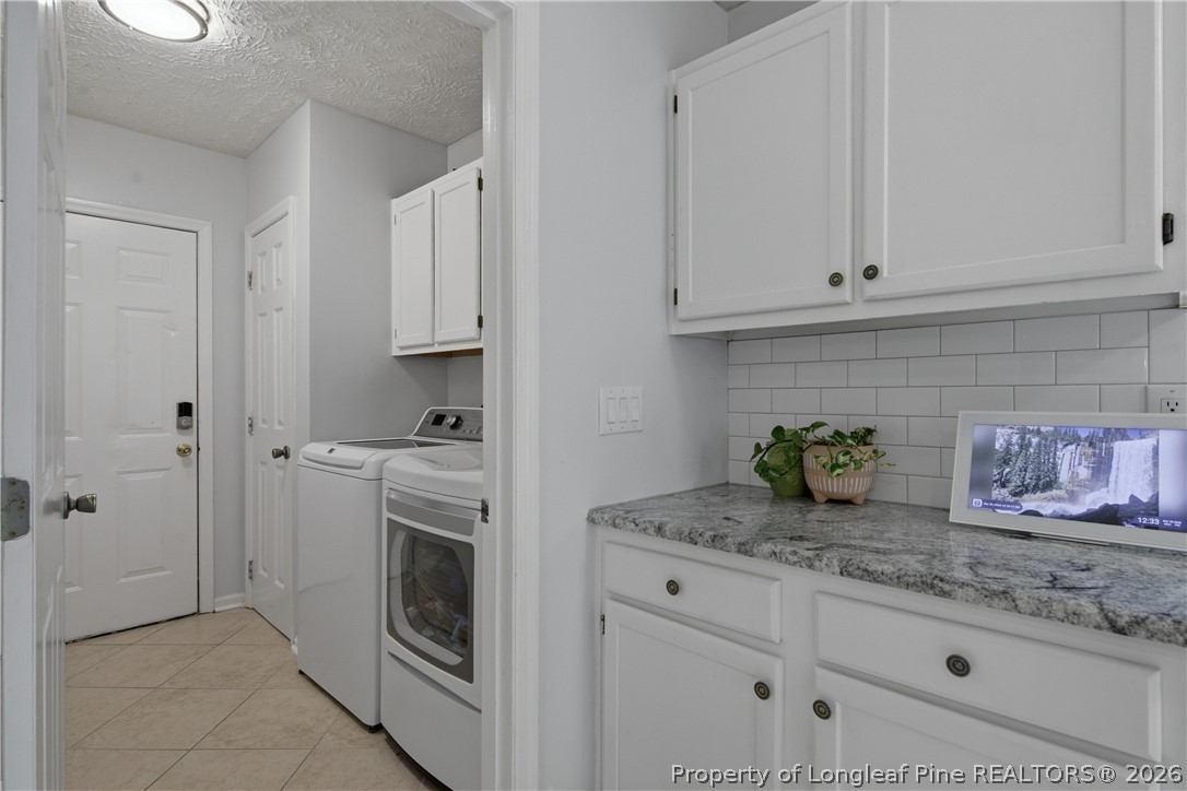 1837 Nuthatch Road Fayetteville, NC 28304 - Photo 18 of 43 a kitchen with granite countertop white cabinets and stainless steel appliances