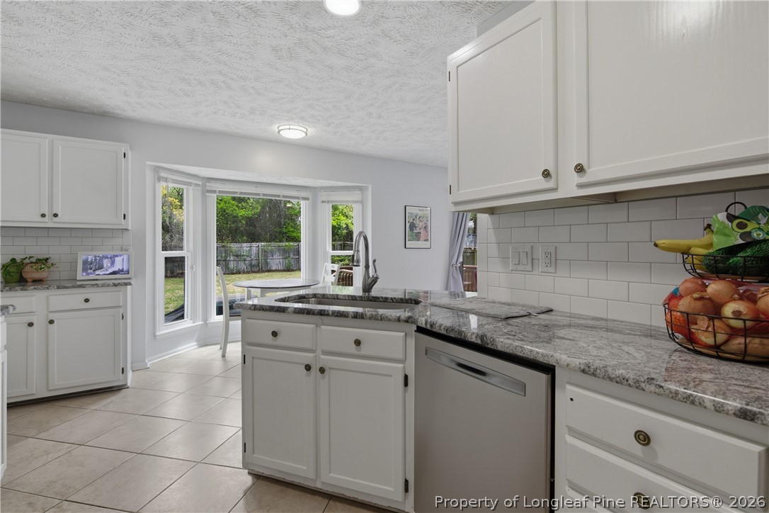 1837 Nuthatch Road Fayetteville, NC 28304 - Photo 21 of 43 a kitchen with granite countertop white cabinets and a sink