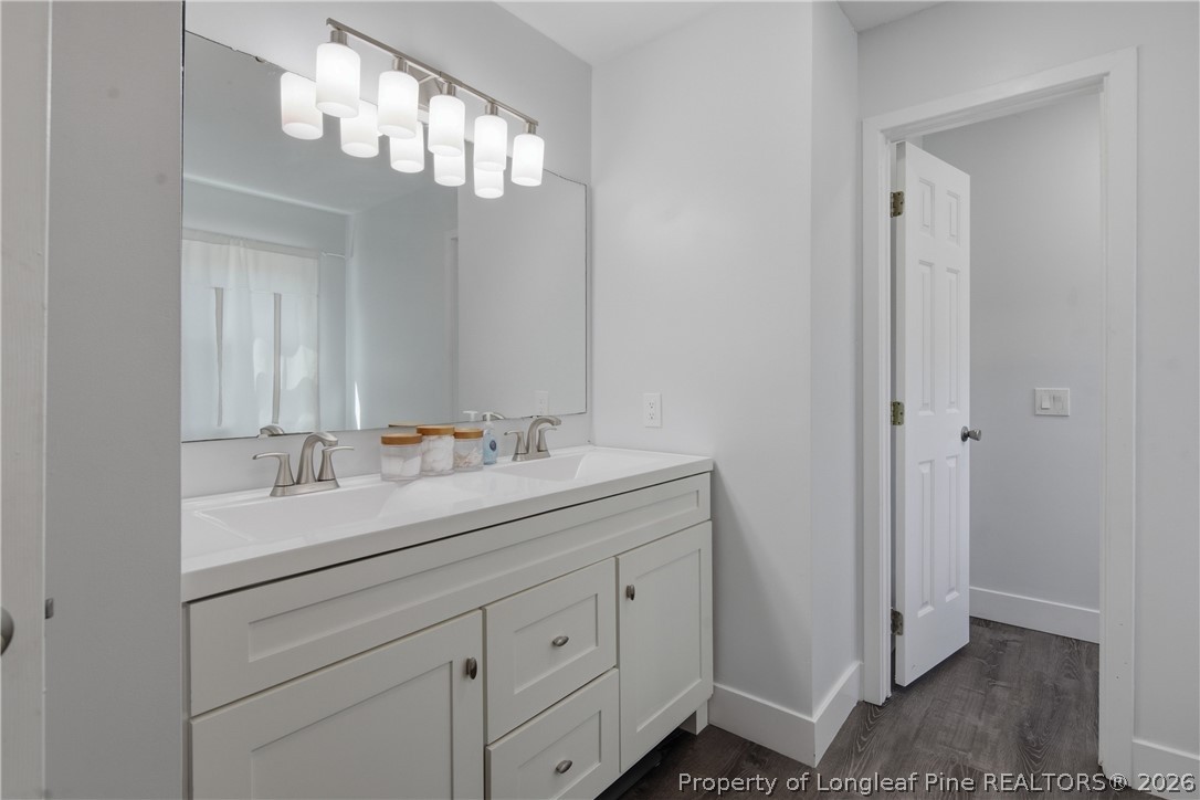 1837 Nuthatch Road Fayetteville, NC 28304 - Photo 27 of 43 a bathroom with a double vanity sink and a mirror