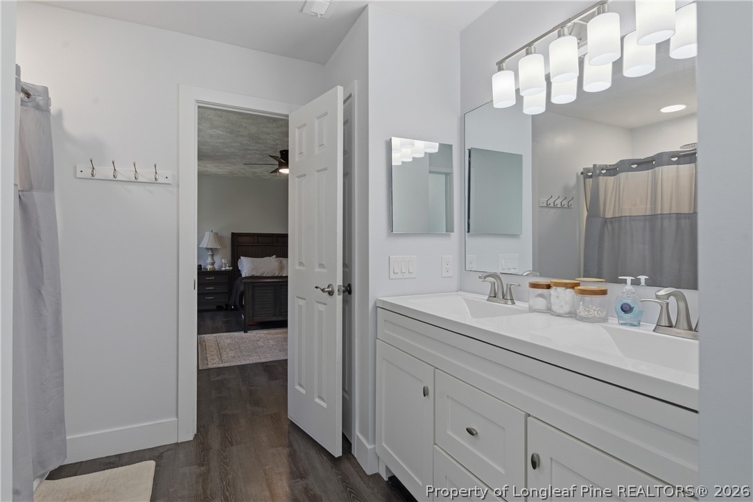 1837 Nuthatch Road Fayetteville, NC 28304 - Photo 29 of 43 a en suite bathroom with a sink a mirror and shower