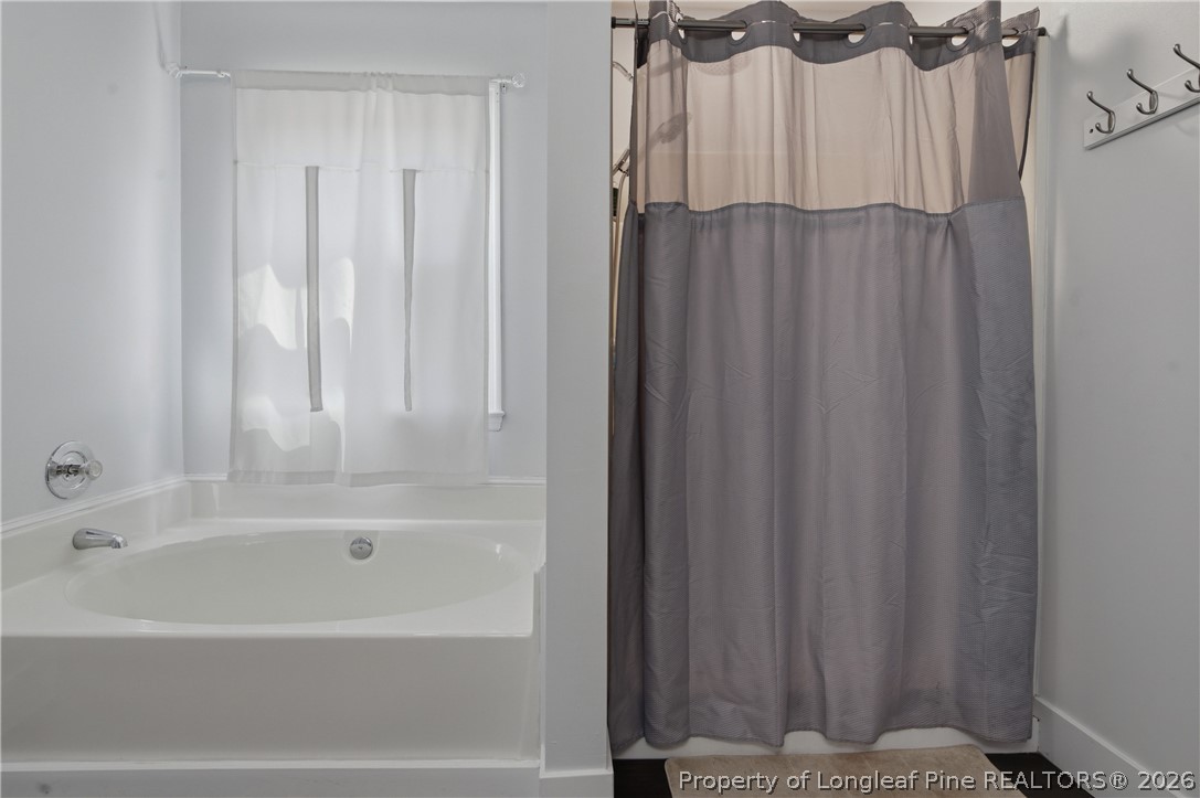 1837 Nuthatch Road Fayetteville, NC 28304 - Photo 30 of 43 a bathroom with a shower curtain and a curtain