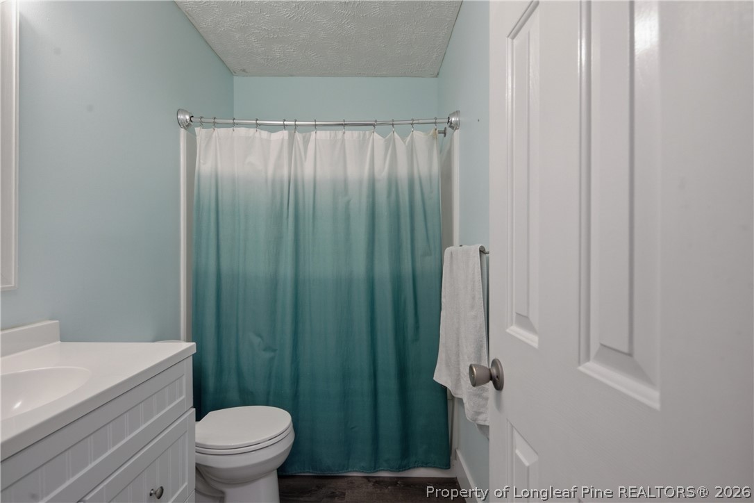1837 Nuthatch Road Fayetteville, NC 28304 - Photo 37 of 43 a bathroom with a shower a toilet and sink