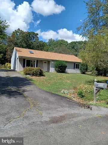 a view of house with outdoor space and garden