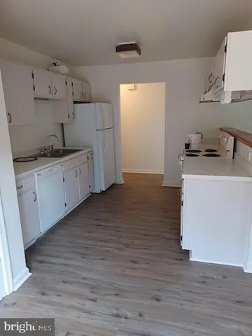 a kitchen with granite countertop a sink and a stove top oven