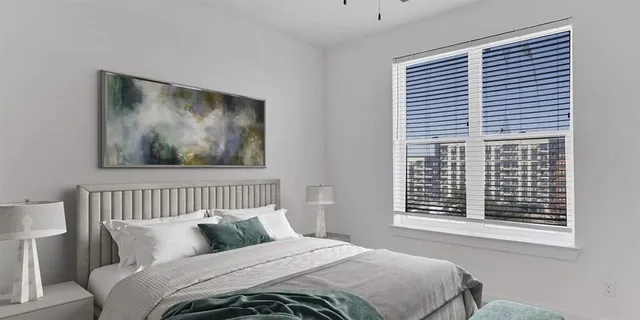 a bedroom with a bed and a window