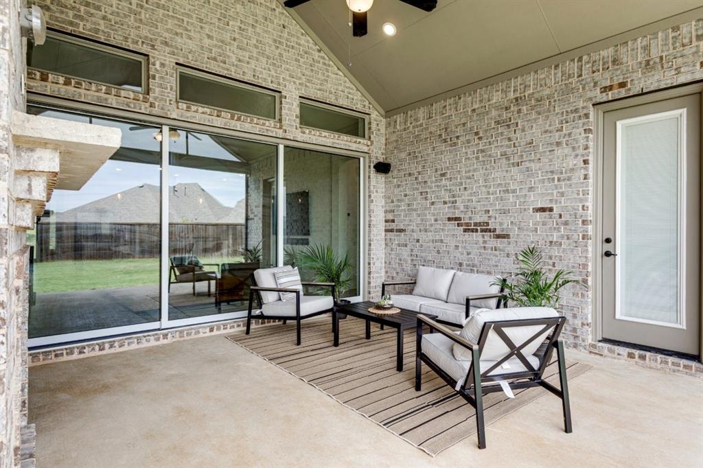 9613 Boulder Pt Road Oak Point, TX 75068 - Photo 16 of 28 Covered outdoor patio featuring a brick exterior and concrete flooring