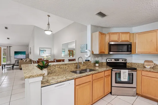 a kitchen with stainless steel appliances granite countertop a stove and a sink