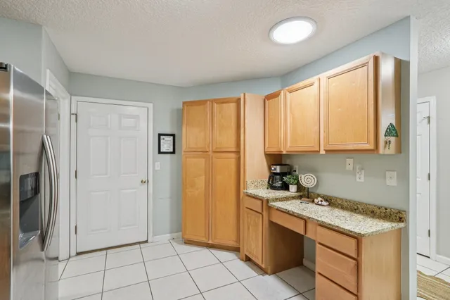 a kitchen with stainless steel appliances granite countertop a refrigerator and a stove