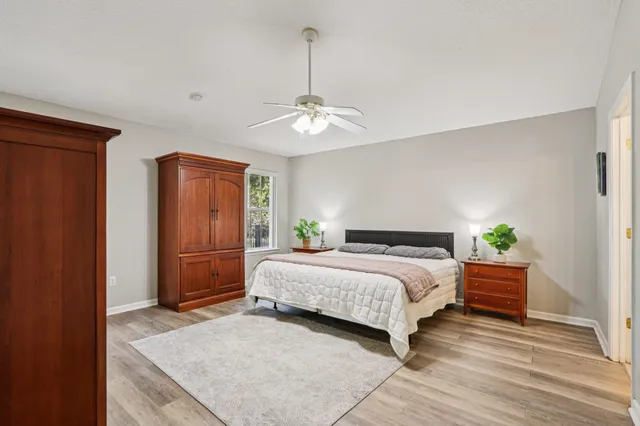 a spacious bedroom with a bed and a chandelier
