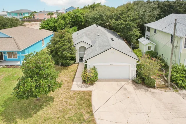an aerial view of a house with a yard and potted plants
