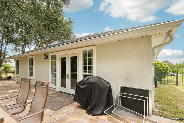 a view of a balcony with chairs and a stove