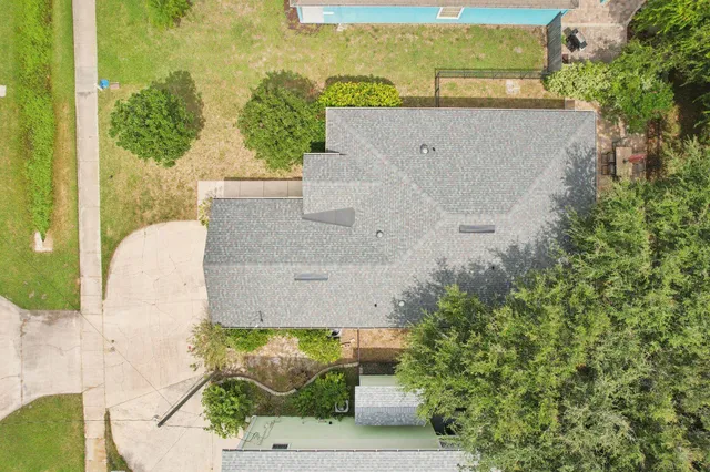 an aerial view of a house with a yard