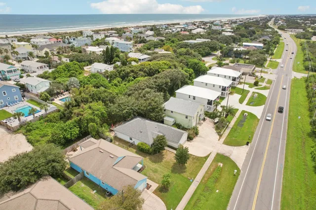 an aerial view of residential houses with outdoor space