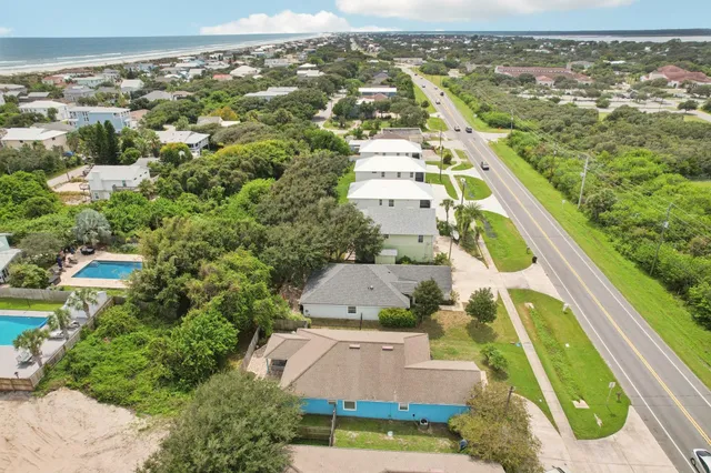 an aerial view of residential houses with outdoor space