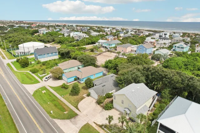 an aerial view of residential houses with outdoor space