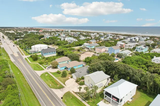 an aerial view of residential houses with outdoor space