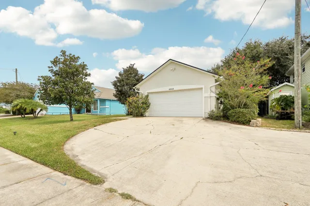 a view of a white house with a yard