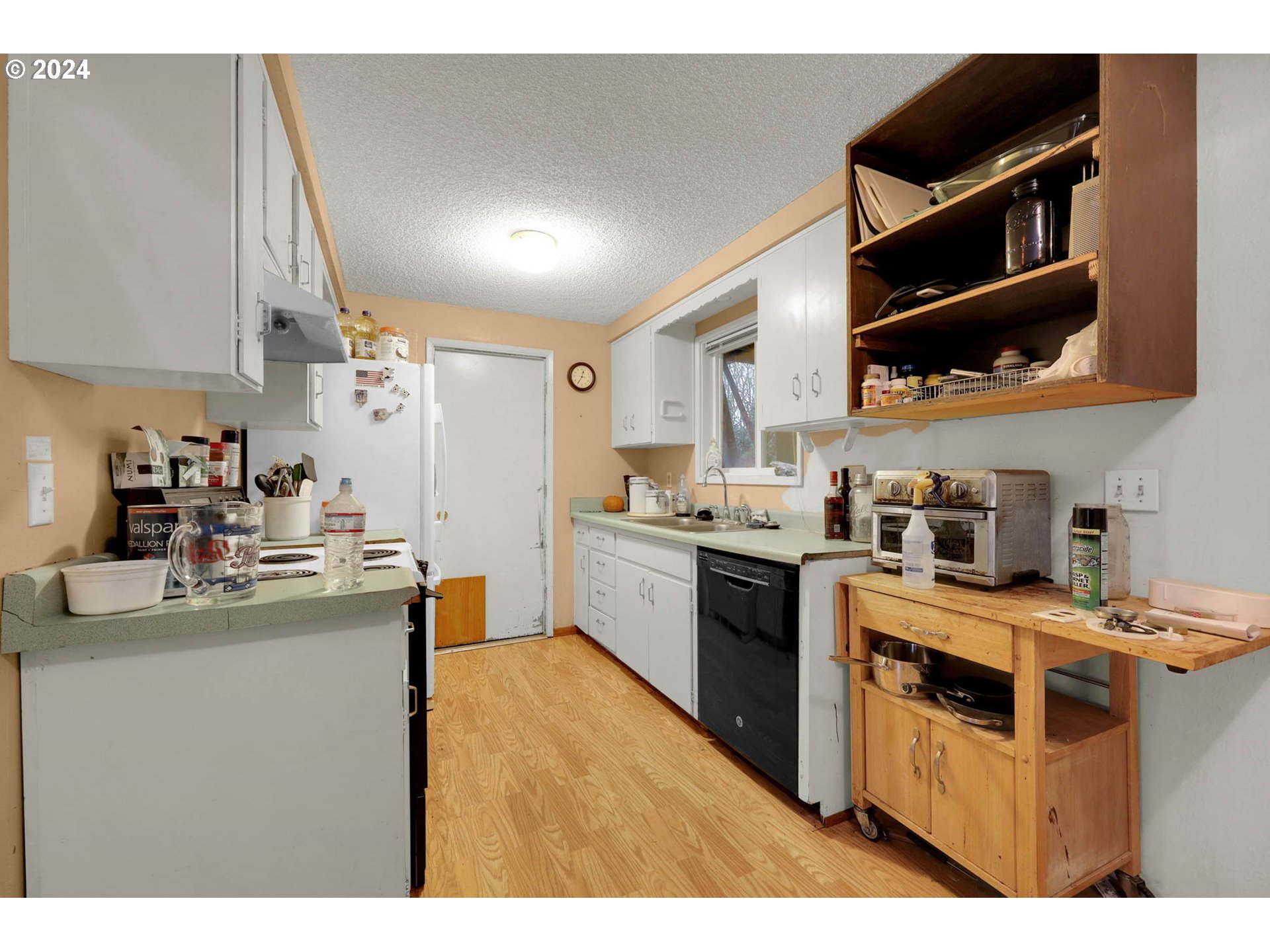 584 North 49th Street Springfield, OR 97478 - Photo 10 of 28 a kitchen with stainless steel appliances granite countertop a stove a sink dishwasher and a refrigerator