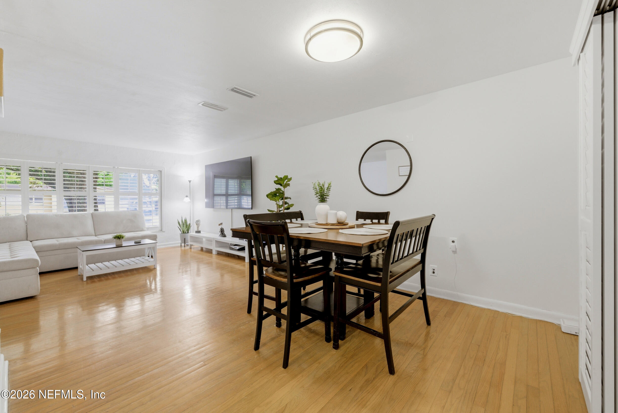 7484 Spinola Road Jacksonville, FL 32217 - Photo 13 of 63 a view of a dining room with furniture and wooden floor