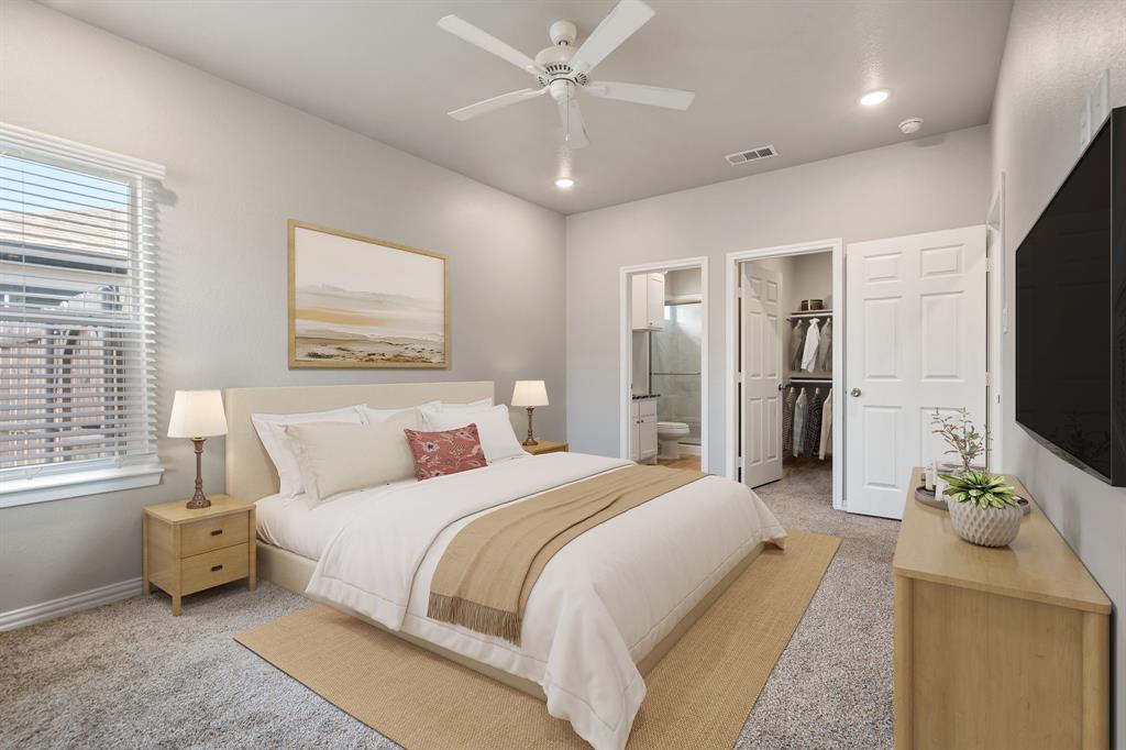 2306 Church Street Greenville, TX 75401 - Photo 2 of 24 a spacious bedroom with a bed and a flat screen television