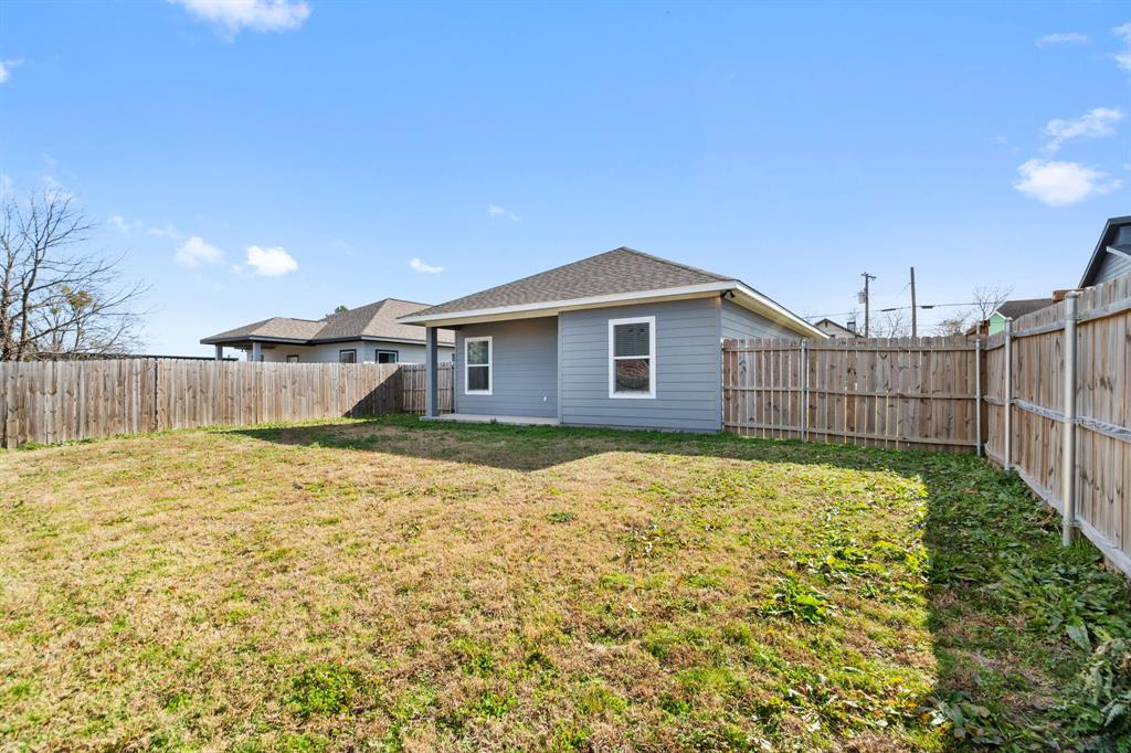 2306 Church Street Greenville, TX 75401 - Photo 24 of 24 a view of a house with backyard and tree