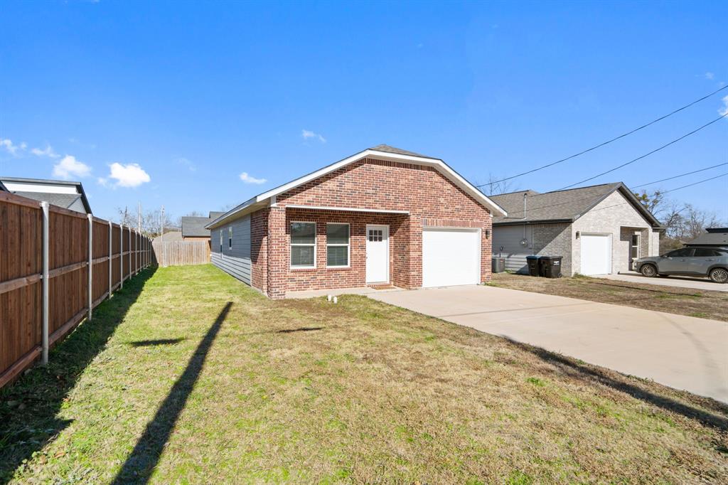 2306 Church Street Greenville, TX 75401 - Photo 5 of 24 a view of a house with a backyard