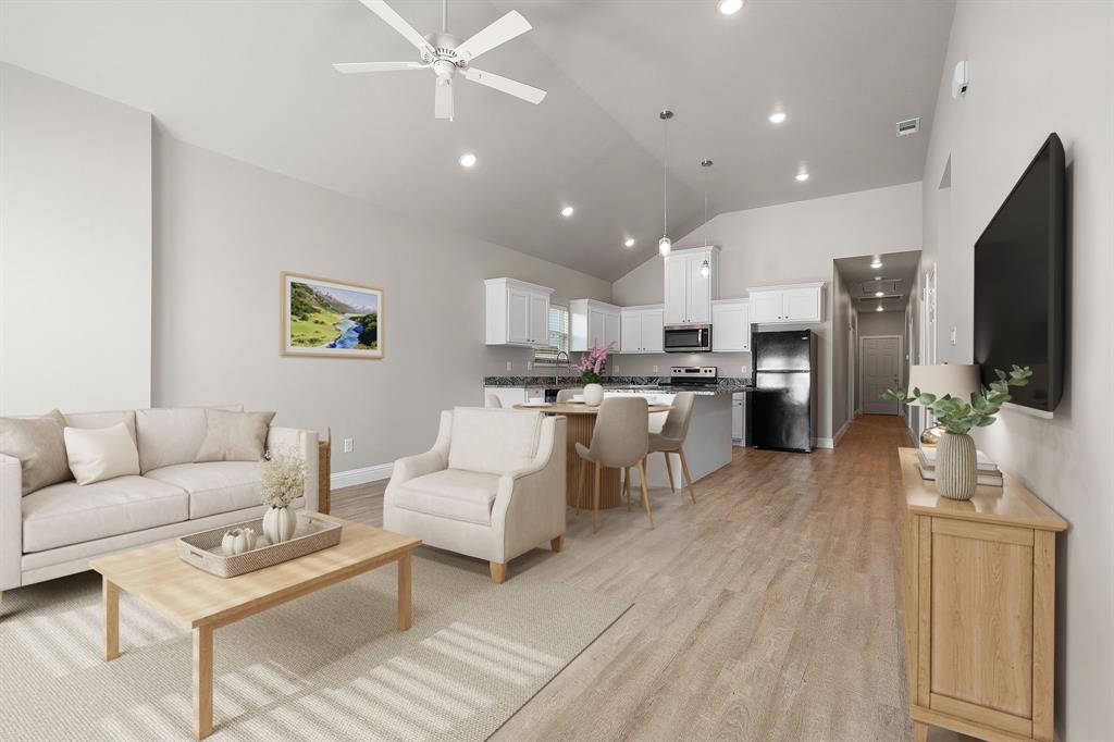 2306 Church Street Greenville, TX 75401 - Photo 9 of 24 a living room with stainless steel appliances furniture and a flat screen tv