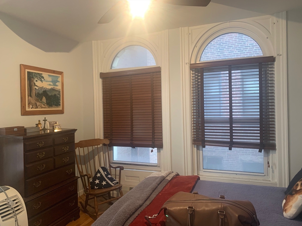 483 Beacon Street, Unit 26 Boston, MA 02115 - Photo 6 of 9 a bedroom with a bed and a window