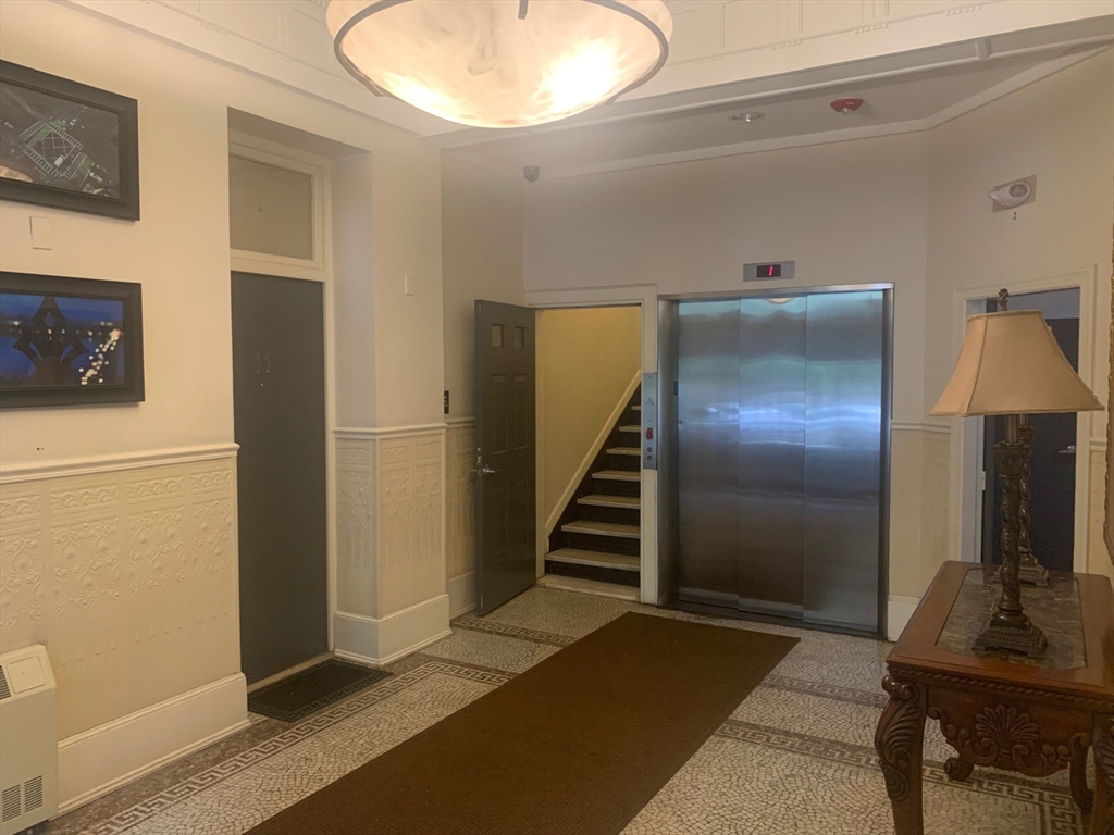 483 Beacon Street, Unit 26 Boston, MA 02115 - Photo 9 of 9 a view of a livingroom with furniture and staircase