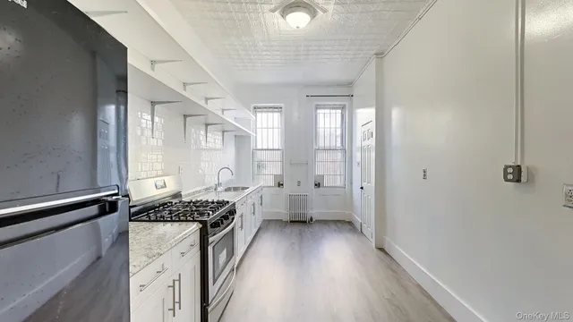 a kitchen with a refrigerator and a stove top oven