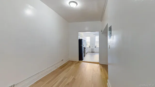 a kitchen with a refrigerator a sink and cabinets