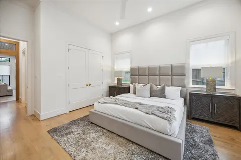 a bedroom with a bed and wooden floor