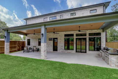 a view of a chairs and table in patio next to a yard