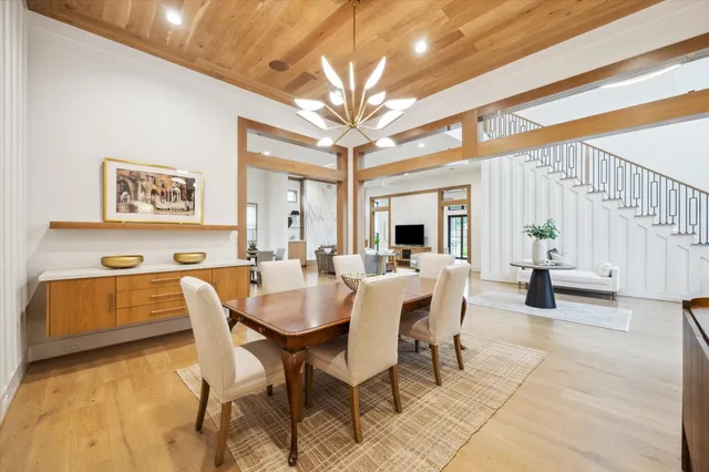 a view of a dining room with furniture and a chandelier