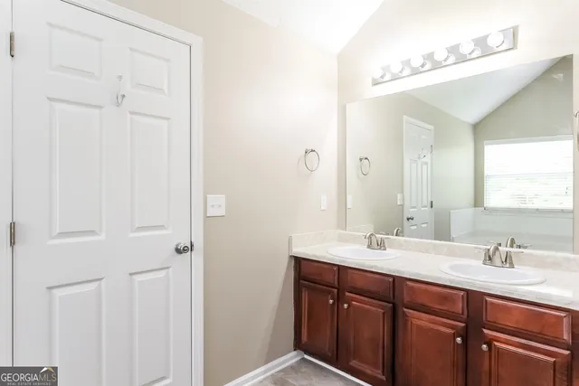a bathroom with a double vanity sink and a mirror
