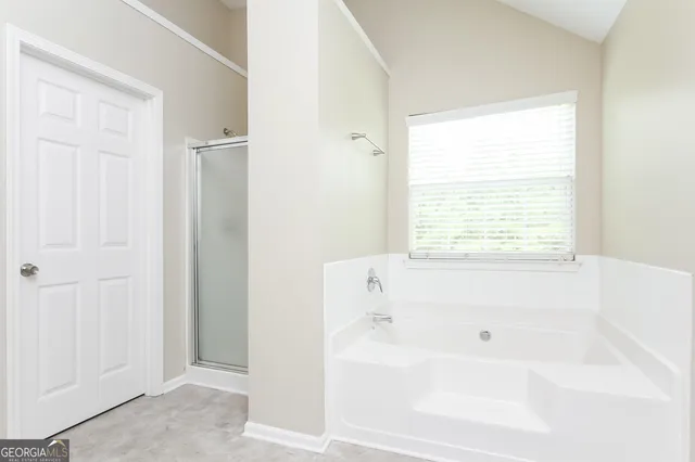 a white bath tub sitting next to a window
