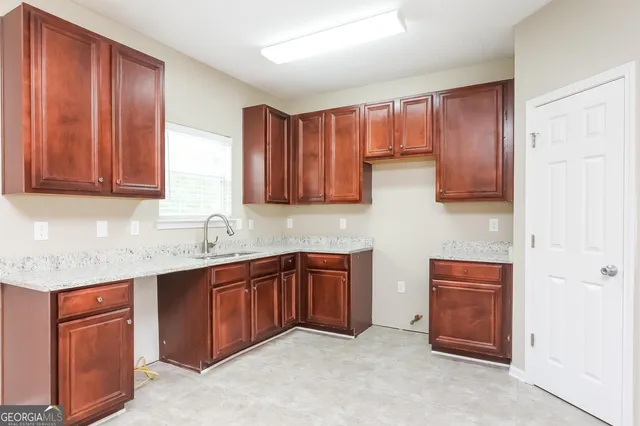 a kitchen with stainless steel appliances granite countertop wooden cabinets a sink and dishwasher