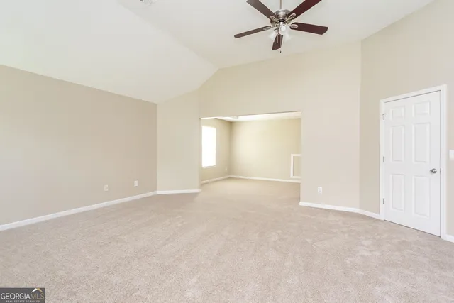 a view of an empty room with a ceiling fan