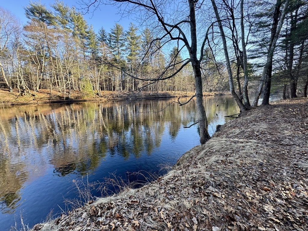 139 Nashua Road Pepperell, MA 01463 - Photo 4 of 6 a view of a lake with houses in the back