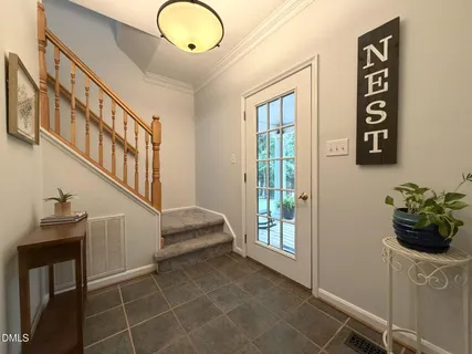 a view of living room with furniture and a potted plant