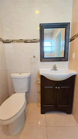 a bathroom with a sink toilet and mirror