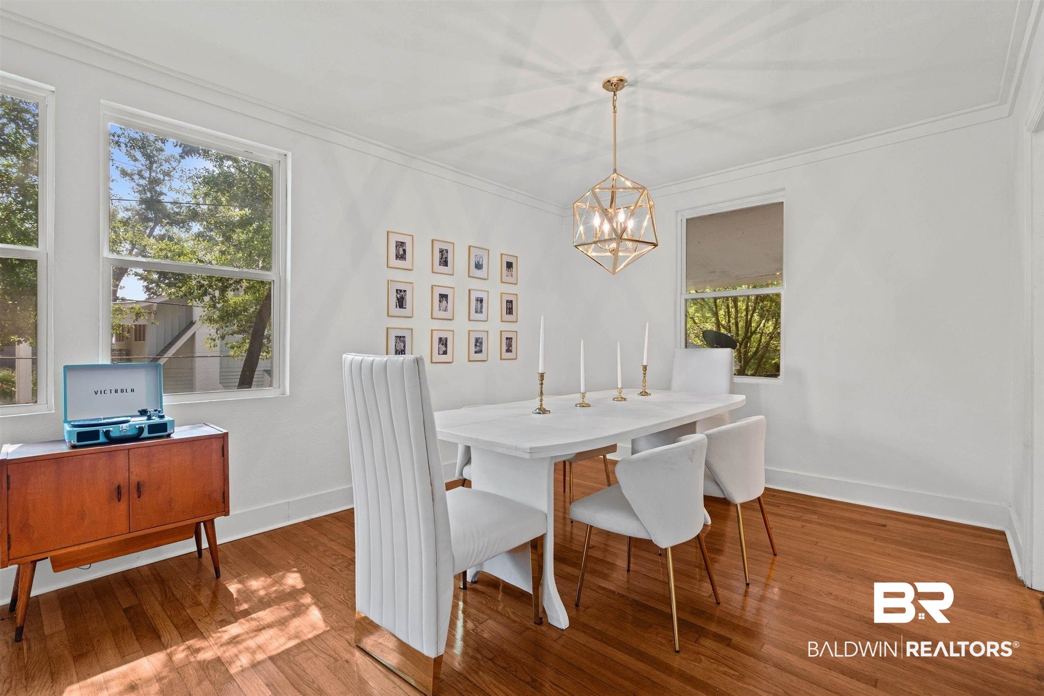 3751 Old Shell Road Mobile, AL 36608 - Photo 3 of 21 Dining area featuring wood-finish flooring, two large windows, and a geometric brass chandelier