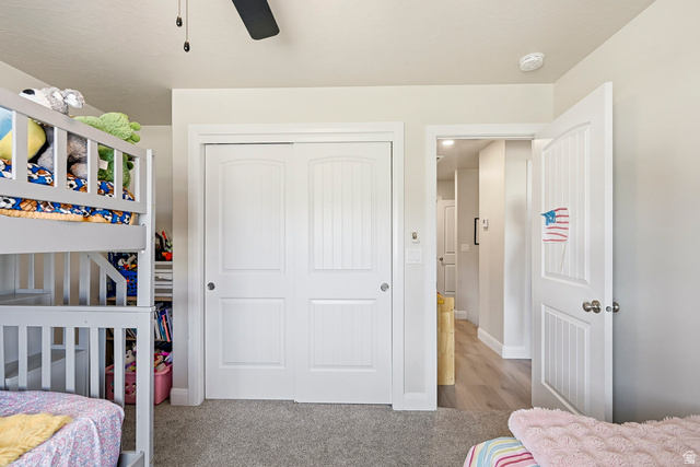 668 East Fiddlers Canyon Road, Unit 6 Cedar City, UT 84721 - Photo 23 of 36 Bedroom featuring a ceiling fan, light gray wall paint, and gray carpet flooring