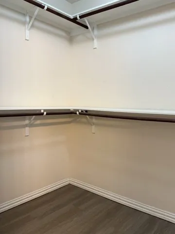 a view of a room with wooden floor